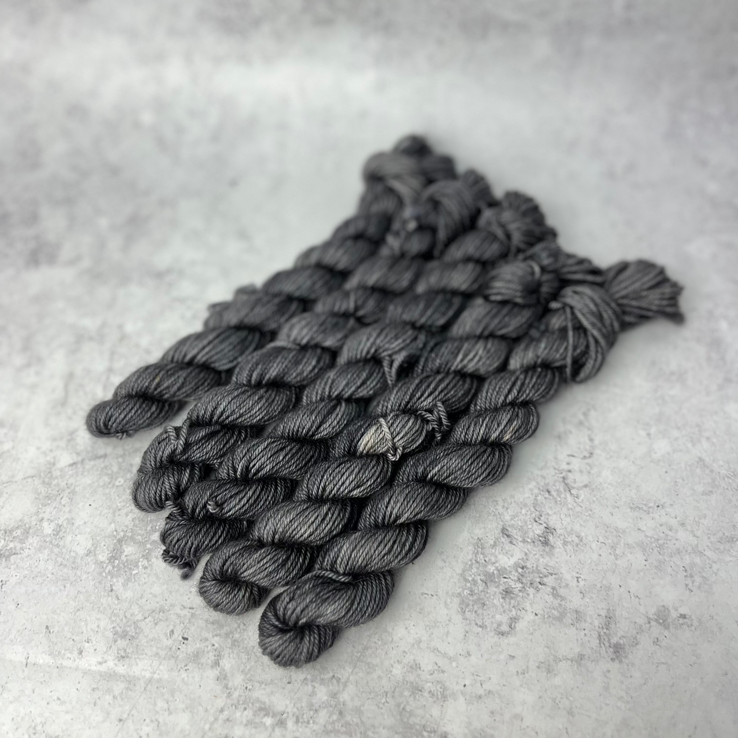 Charcoal Yak DK mini skein shown against a neutral background.
