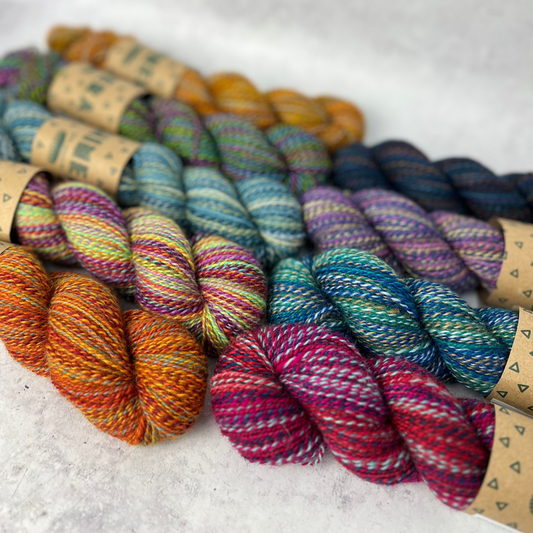 Each colour way of Chimera yarn laid out side by side on a neutral background.