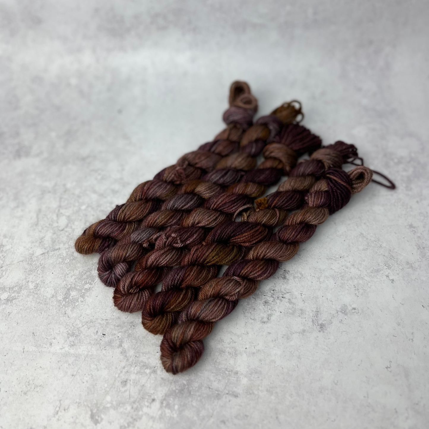 Chocolate Yak DK mini skein shown against a neutral background.