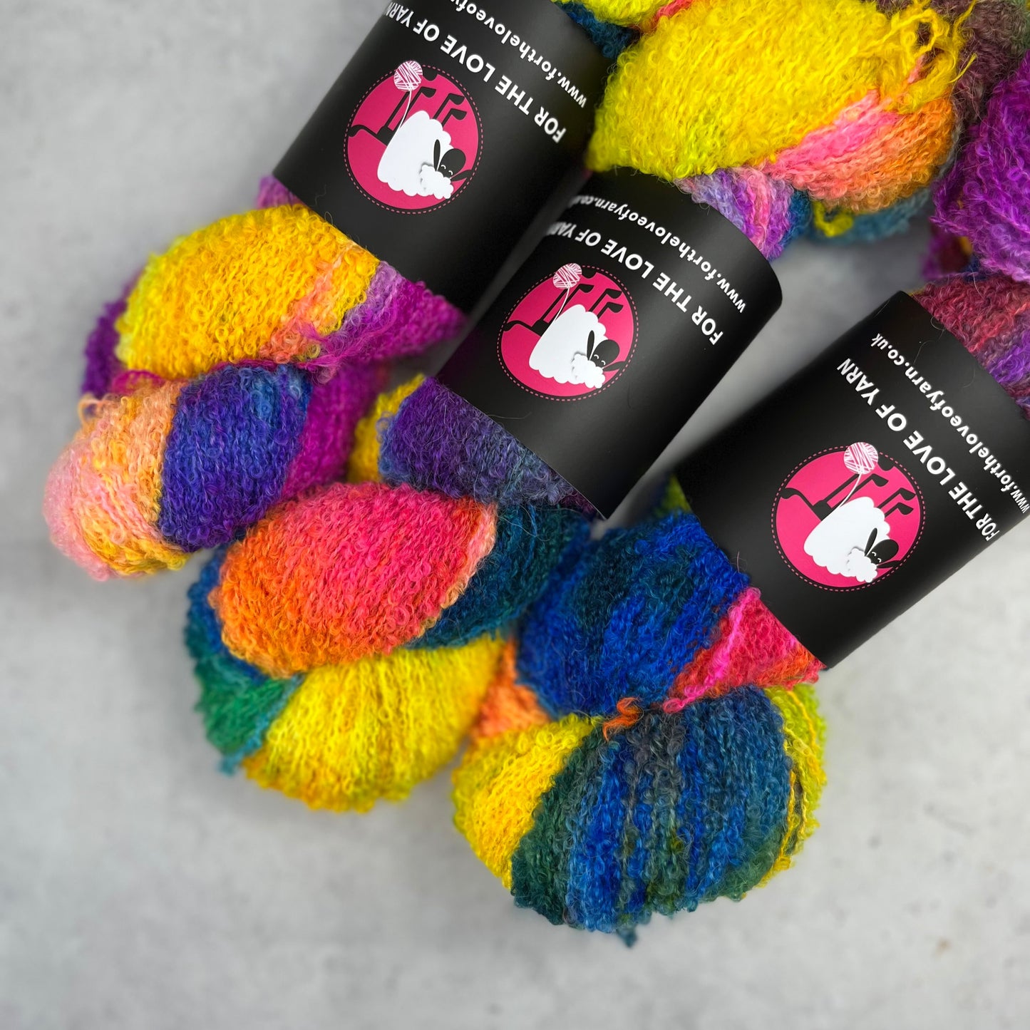 Bright rainbow skeins against a neutral background.