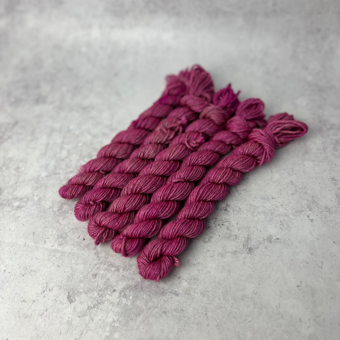 Hot Pink Yak DK mini skein shown against a neutral background.