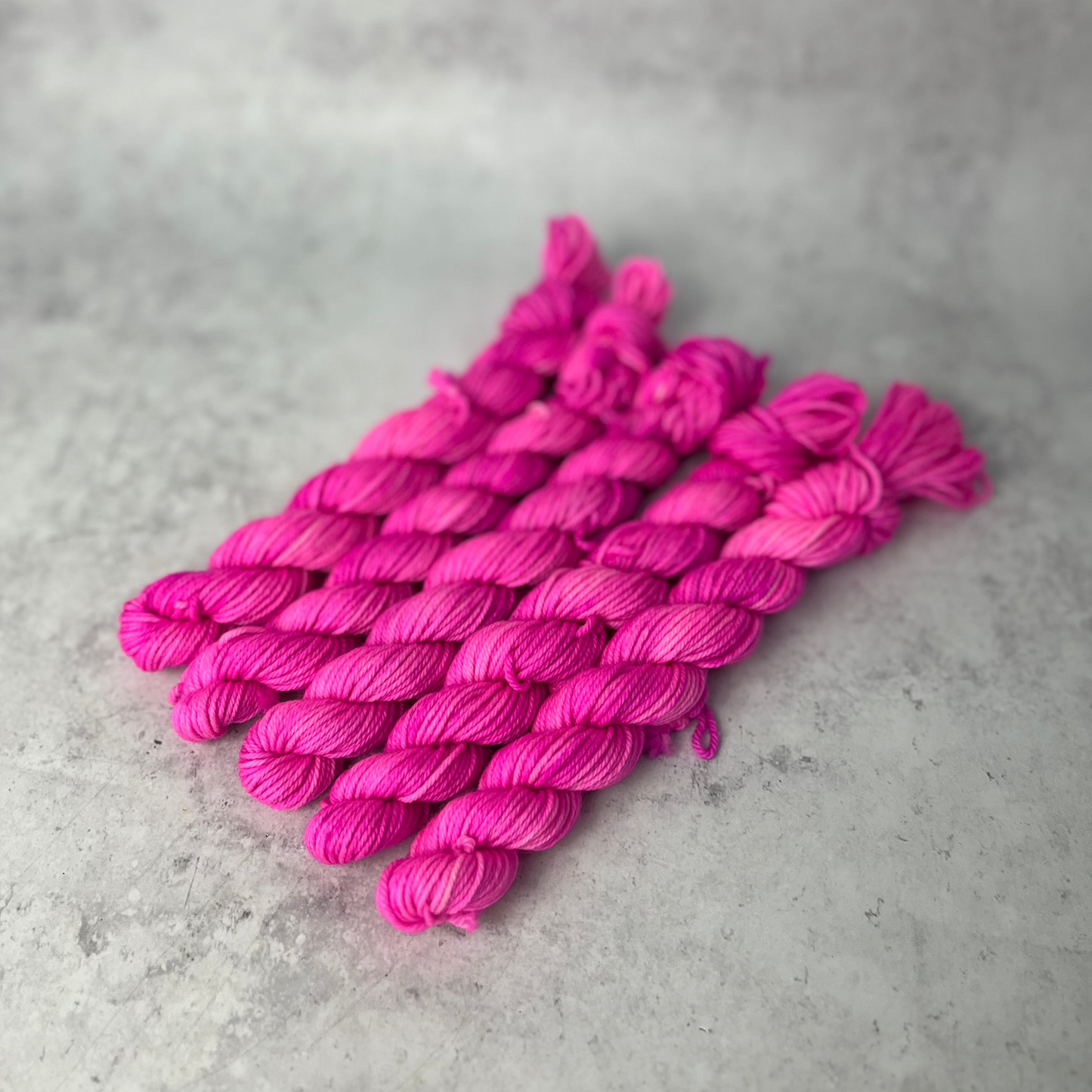 Hot Pink Merino Nylon Mini skein shown against a neutral background.