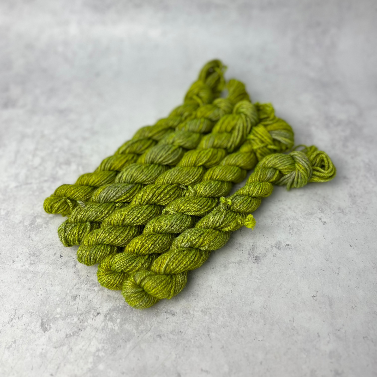 Lime Green Yak DK mini skein shown against a neutral background.