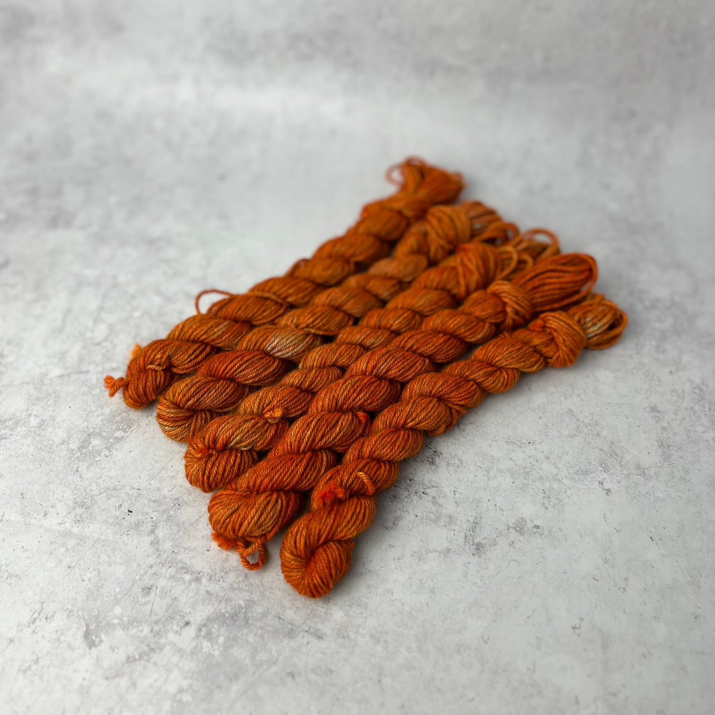 Orange Yak DK mini skein shown against a neutral background.