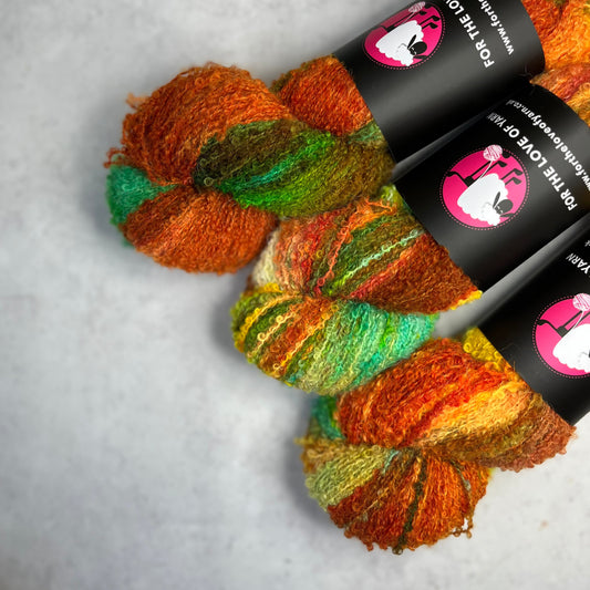 Autumnal coloured skeins on a neutral background.