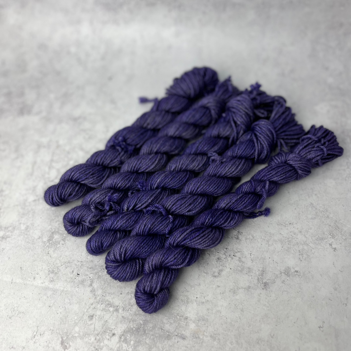 Purple Yak DK mini skein shown against a neutral background.