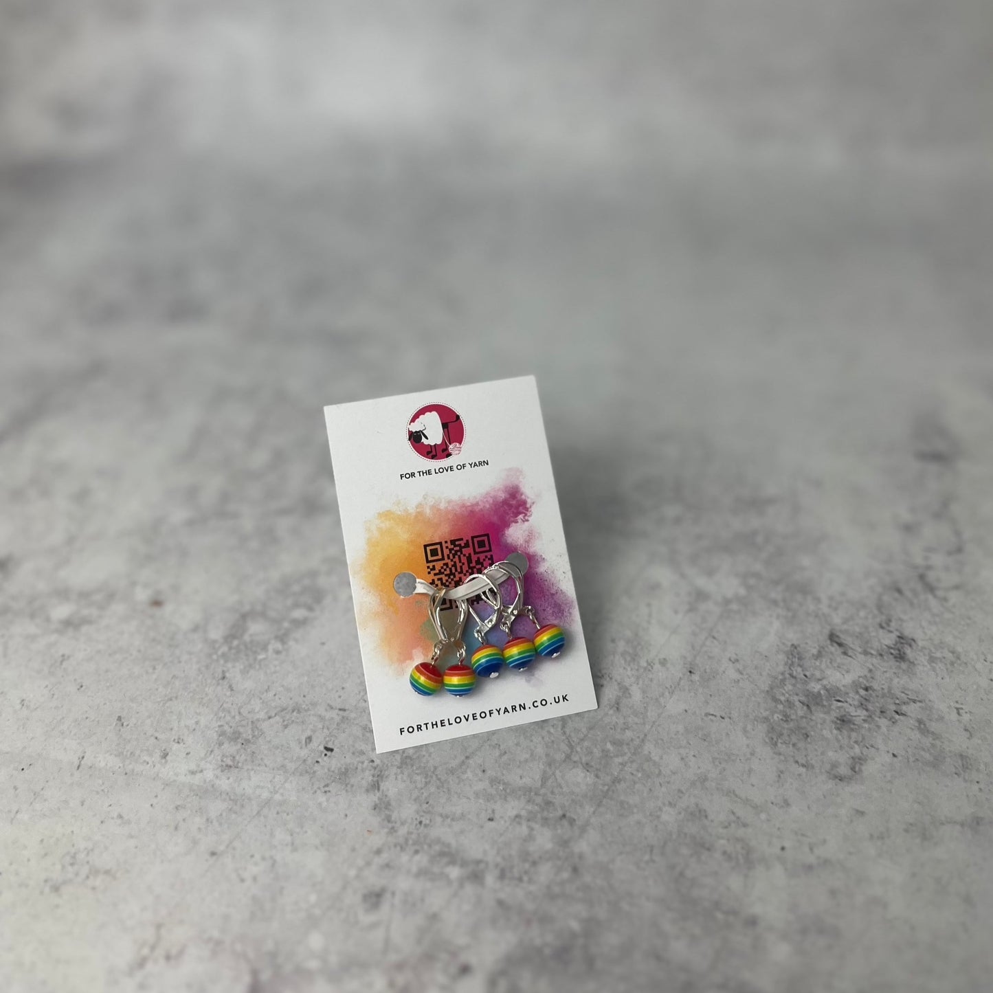 Set of rainbow crochet style stitch markers on backing card.