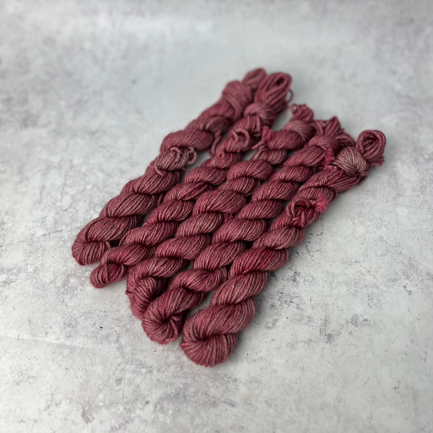 Rose Pink Yak DK mini skein shown against a neutral background.