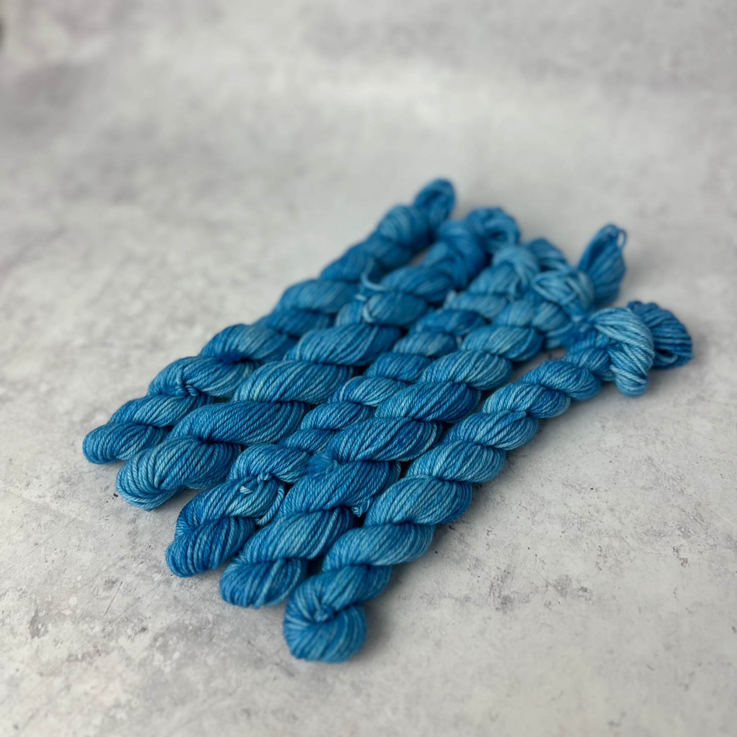 Sky Blue Merino Nylon mini skein shown against a neutral background.