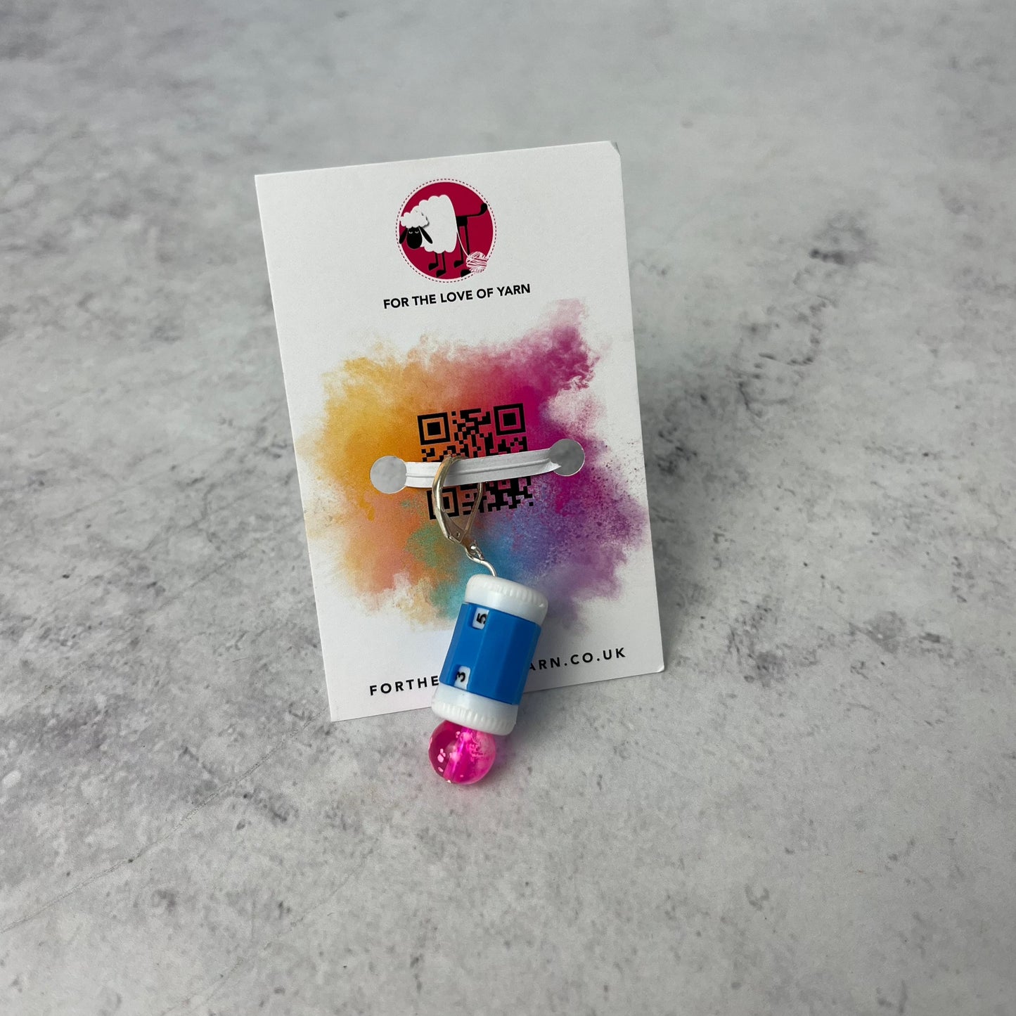 Row counter progress keeper with clasp style attachment, shown on a backing card.