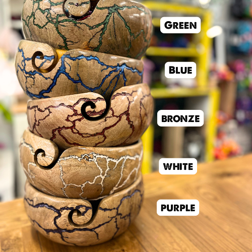 A stack of yarn bowls with text labels showing the different colours of fractal burn designs available.