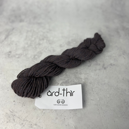 Skein of Firemore with label showing, set against a neutral background.