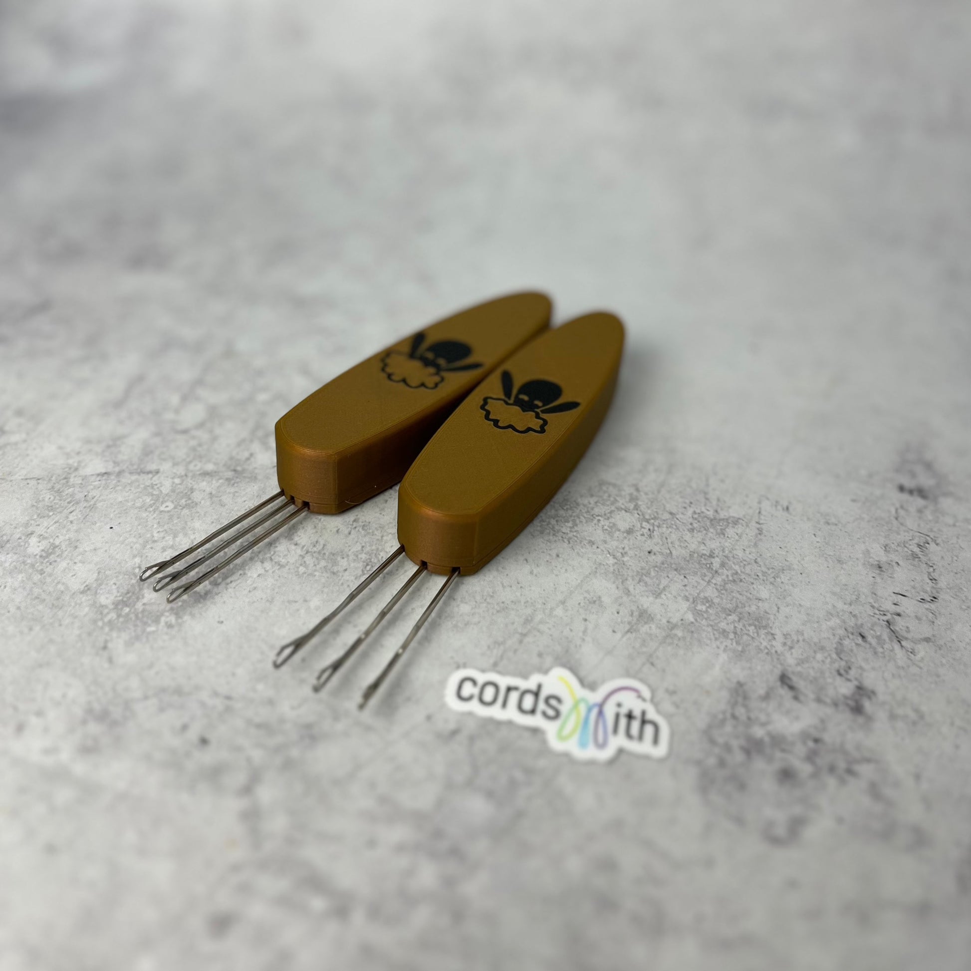 Gold Cordsmith tools, Mini on the left, Original on the right.