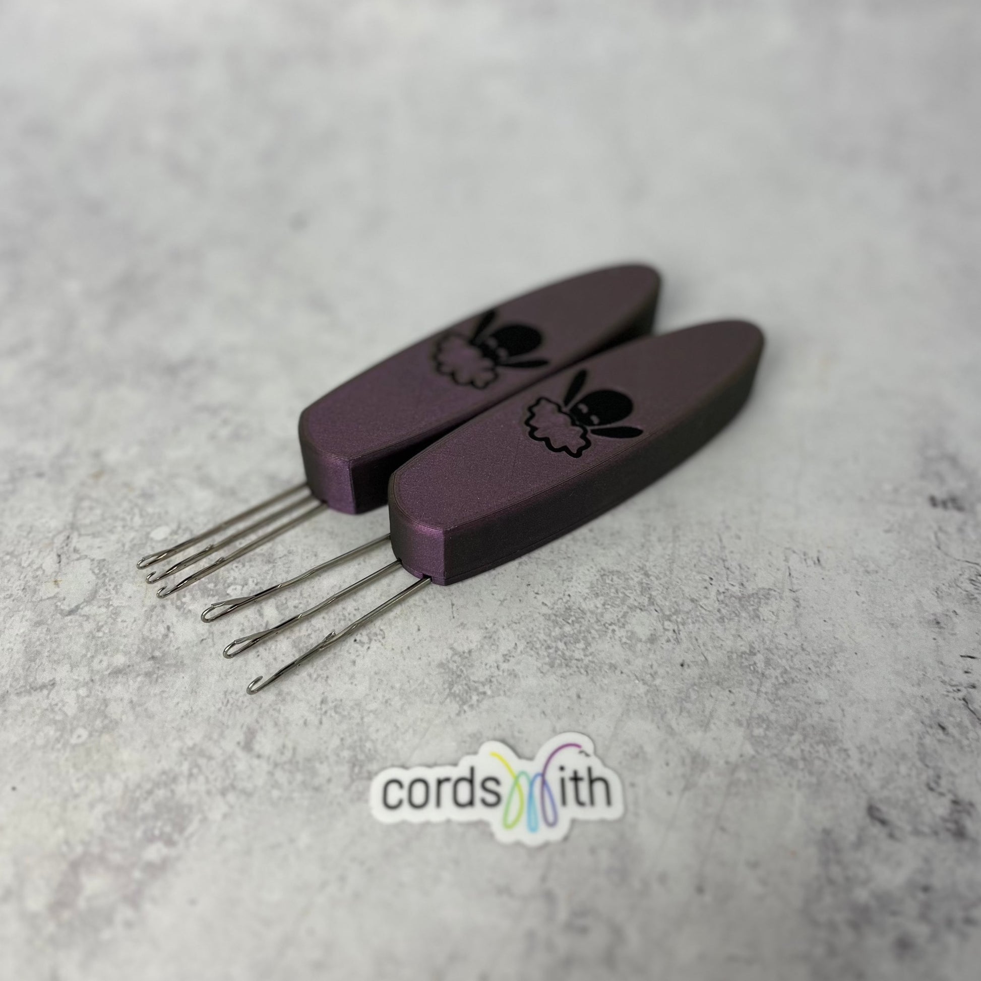 Cordsmith Pink tool, mini size on the left, and original on the right.