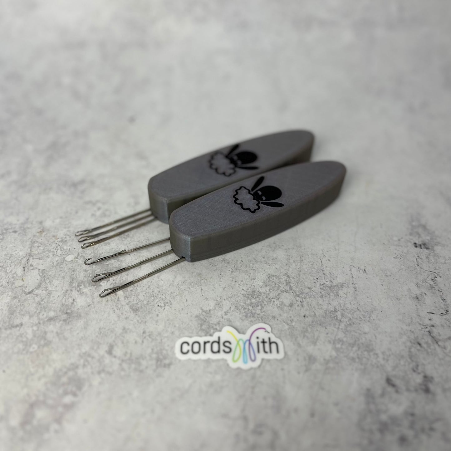 Cordsmith Tool in Silver, with Mini size on the left and original on the right.