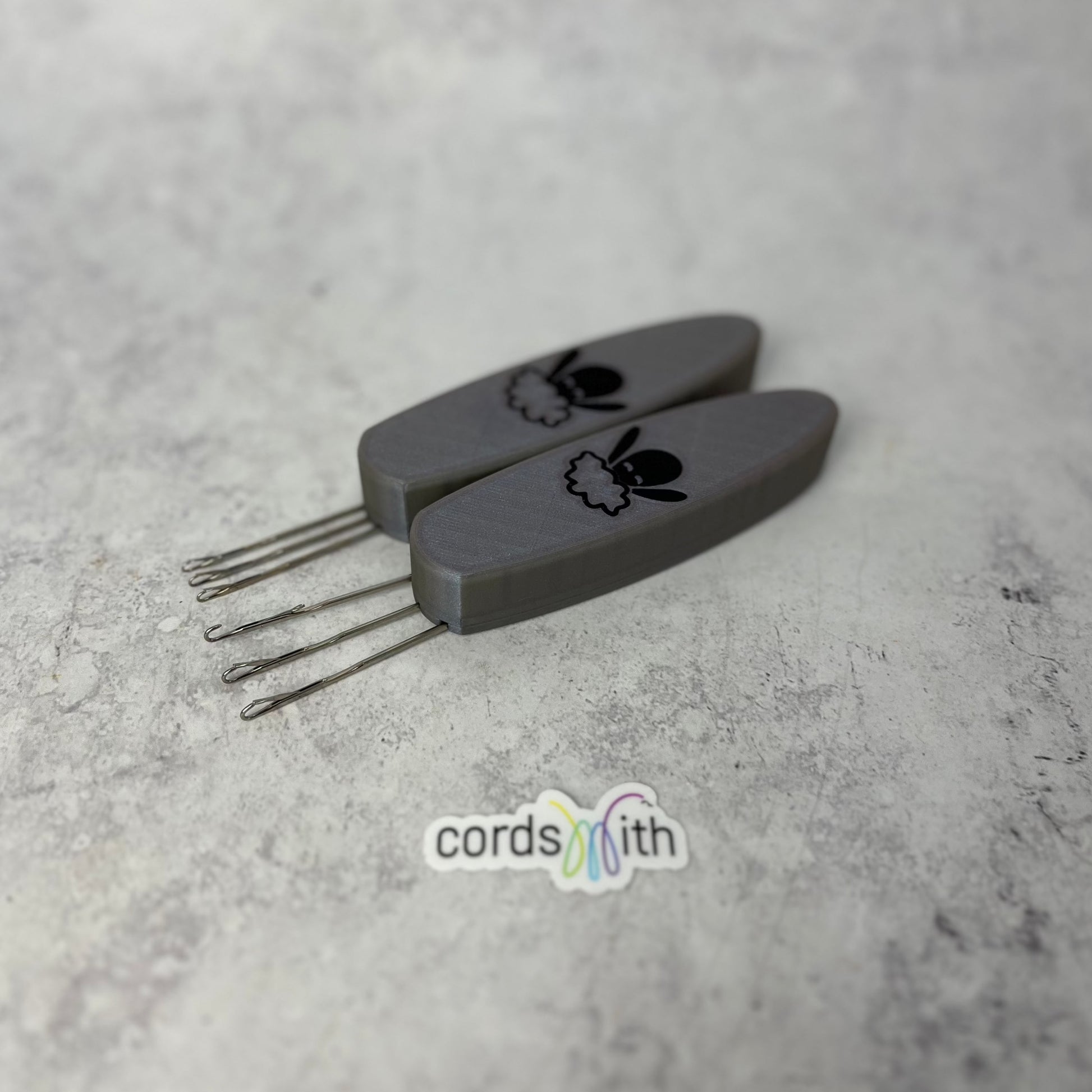 Cordsmith Tool in Silver, with Mini size on the left and original on the right.