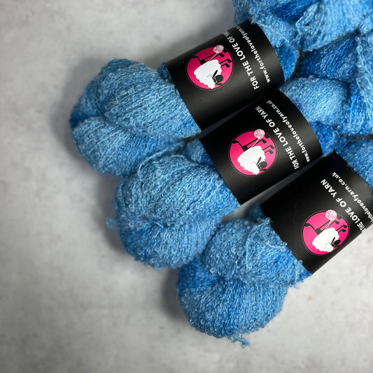 Three blue skeins against a neutral background.