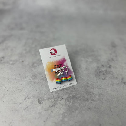 Set of "rainbow" progress keepers with clasp style attachment, shown on a backing card.